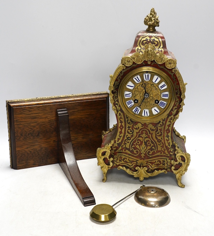 A Louis XV style red boulle eight day mantel clock, with bracket and pendulum, clock 30cm high. Condition - fair, not tested